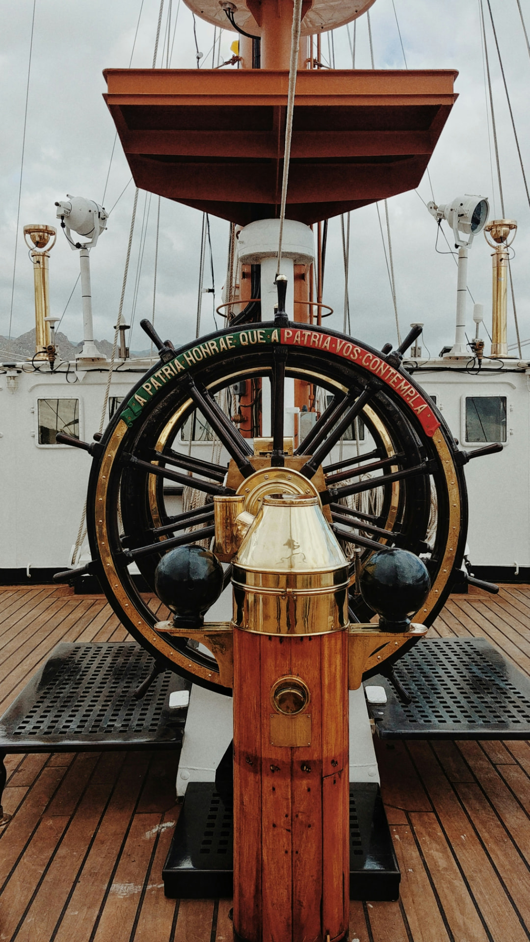 Helm and binnacle compass on the deck of a tall ship